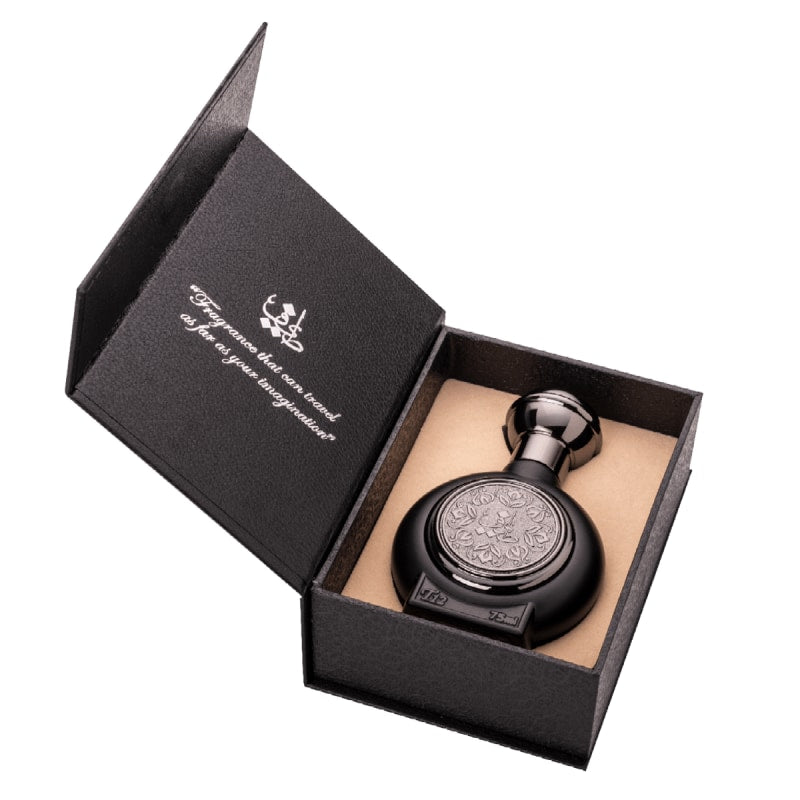 Black decorative bottle in an open black box with a visible brand logo (Taif Al Emarat) on a white background
