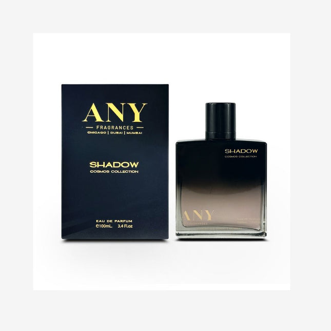 A square black glass bottle of ANY Shadow Cosmos Collection Eau de Parfum 100mL. The bottle has a gradient effect, transitioning from dark grey to black. It has a silver cap and a silver band around the bottom. The matching box is black with silver lettering and the brand name 'ANY'