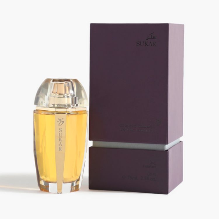 Perfume bottle and packaging with 'SUKAR' branding on a white background