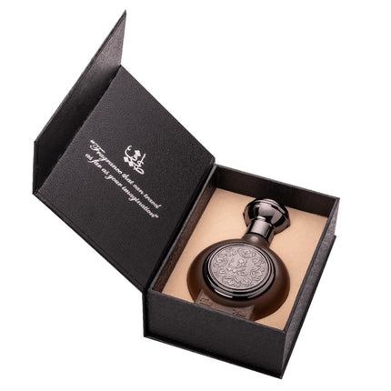 Decorative bottle in a black box with visible brand logo on a white background