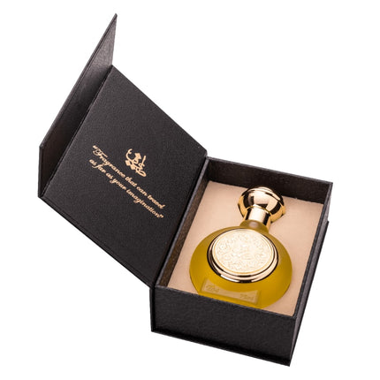 Gold perfume bottle in a black box with a visible brand logo on a white background. It is a T04 EDP 75mL spray of Taif Al Emarat.