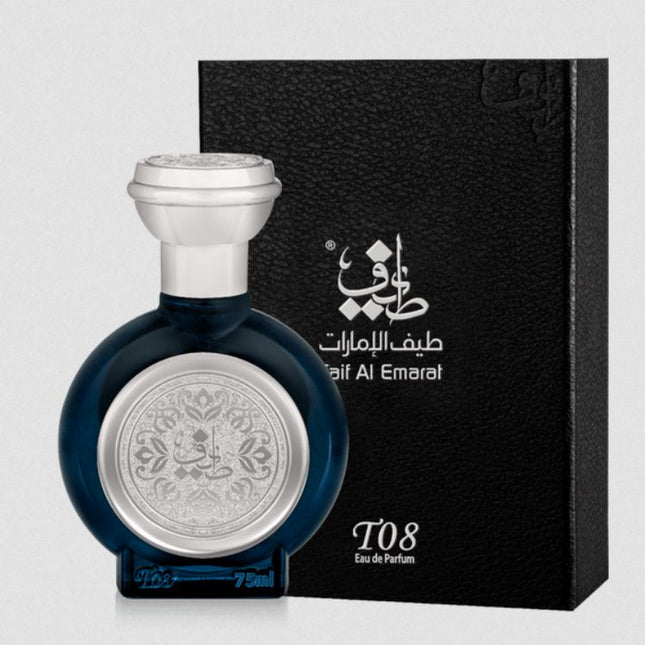 Perfume bottle with silver cap and intricate design next to a black box with brand logo on a light gray background. It is T08 Theyab EDP 75mL by Taif Al Emarat.